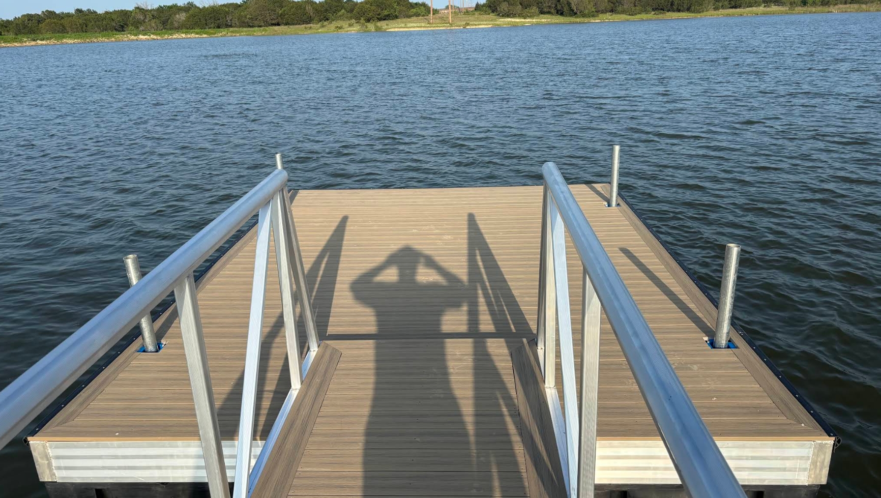 Floating dock with composite decking, aluminum handrails and a gangway on a Texas lake — built by Waters Edge Docks & More